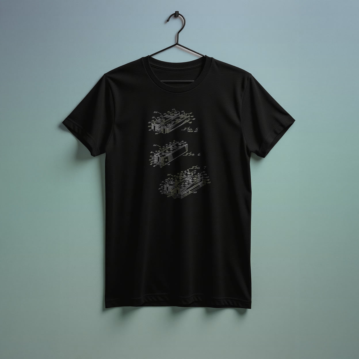 Black t-shirt with a graphic design on a hanger against a light blue wall